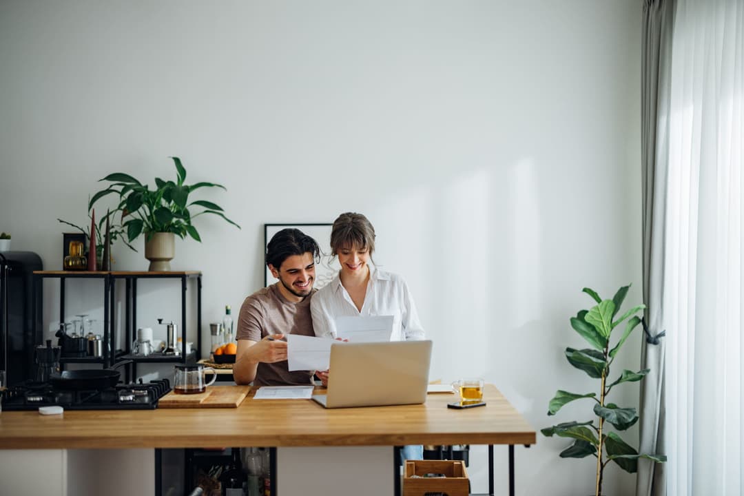 Cheerful Couple Paying Bills at Home