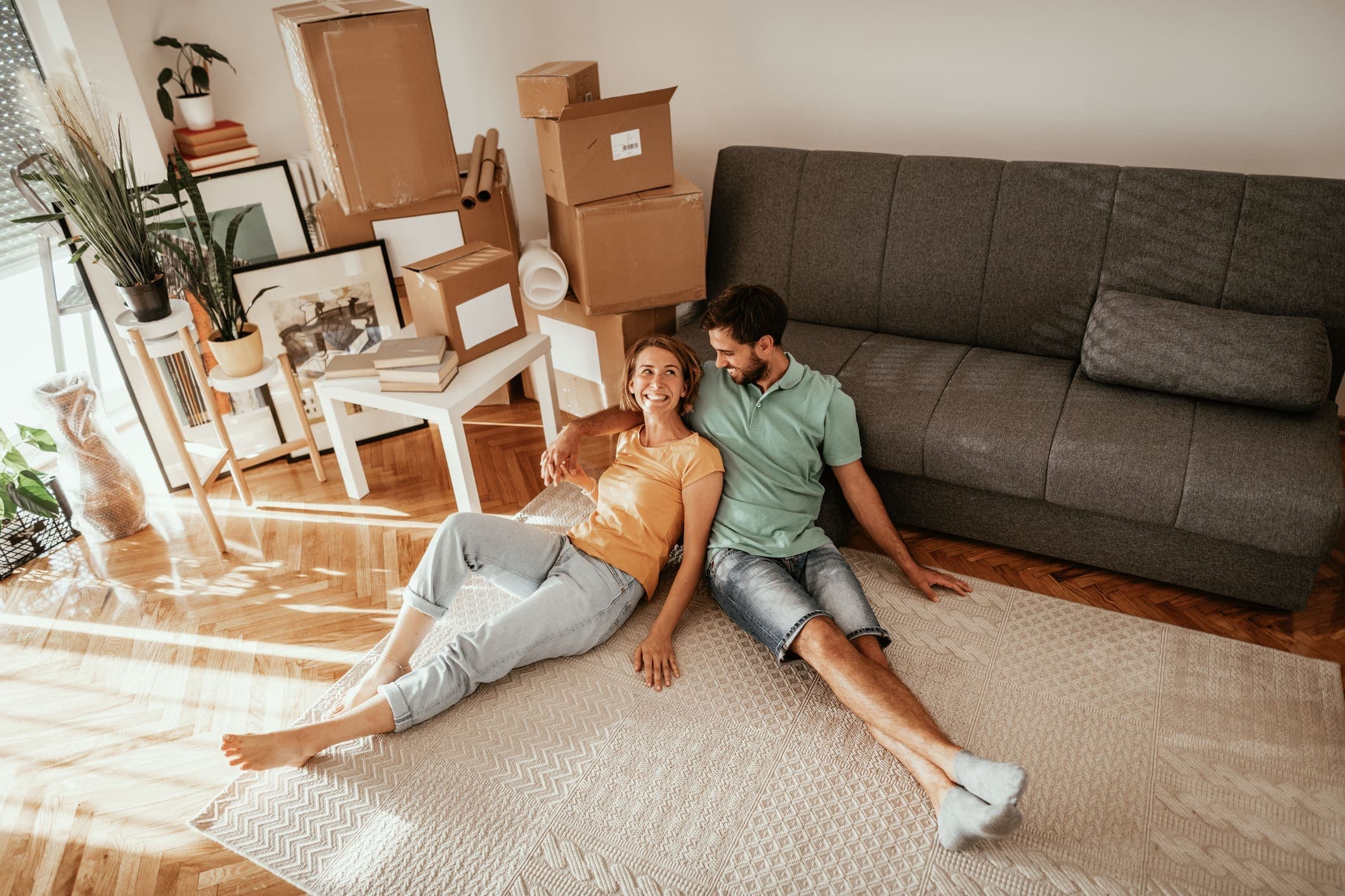 Family moving in new apartment, lying on carpet and sharing love and happiness after moving in.