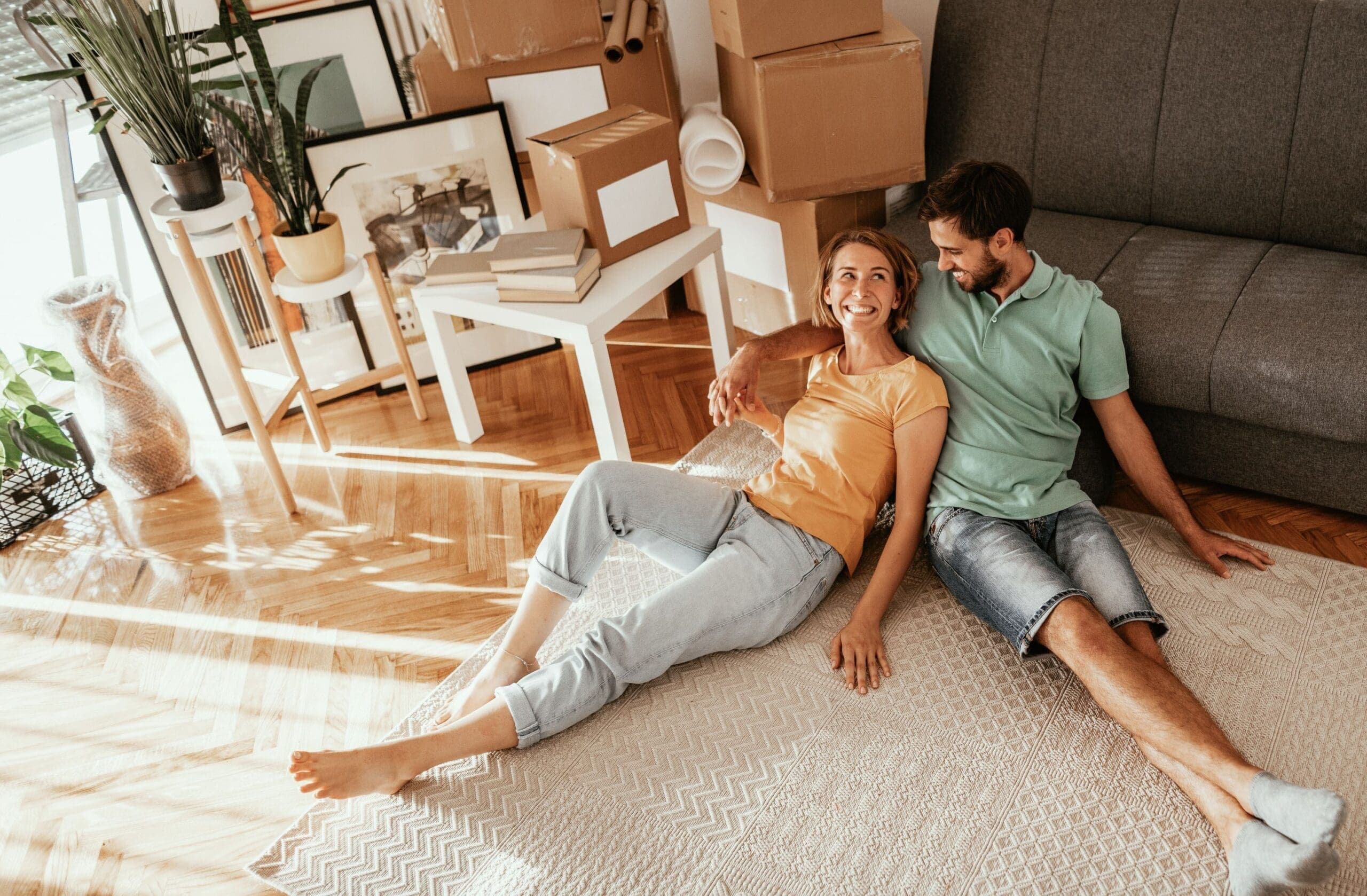 Family moving in new apartment, lying on carpet and sharing love and happiness after moving in.